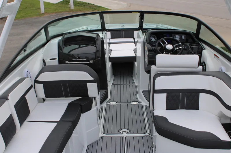 Slide: The Image of 2023 Monterey M6 boat interior with black and white seating and modern dashboard. - 13