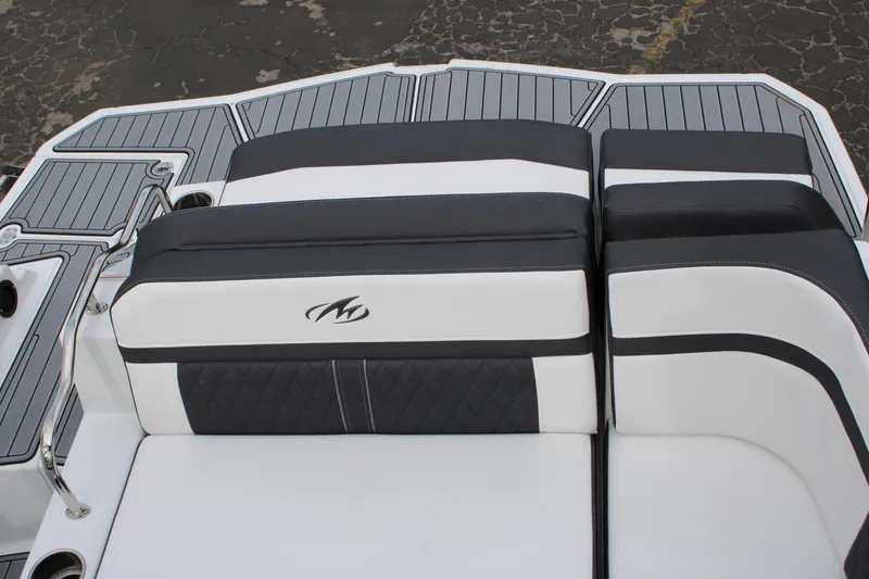 Slide: The Image of 2023 Monterey M6 boat with black and white cushioned seating. - 14