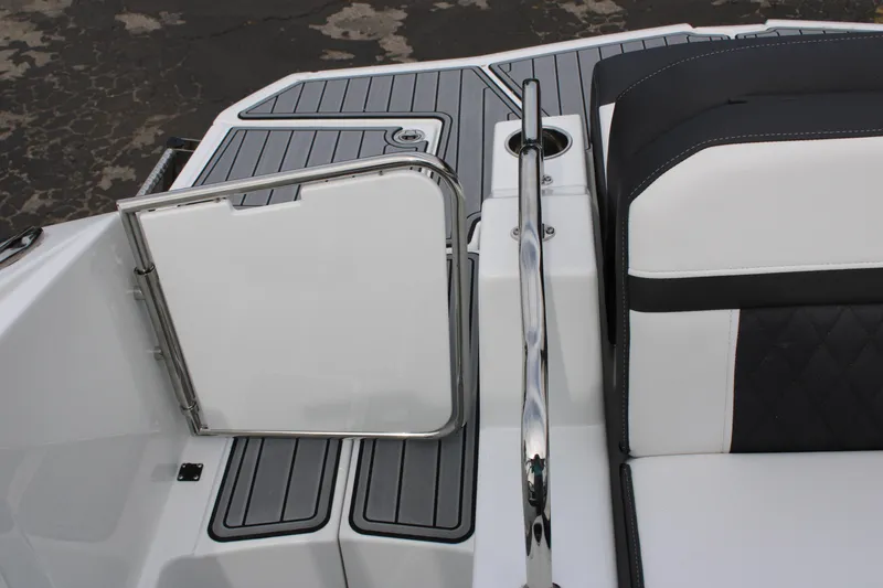 Slide: The Image of 2023 Monterey M6 boat interior with open gate and cushioned seating. - 16