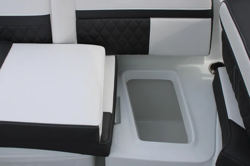 Slide: The Image of 2023 Monterey M6 boat interior with white and black cushioned seating. - 22