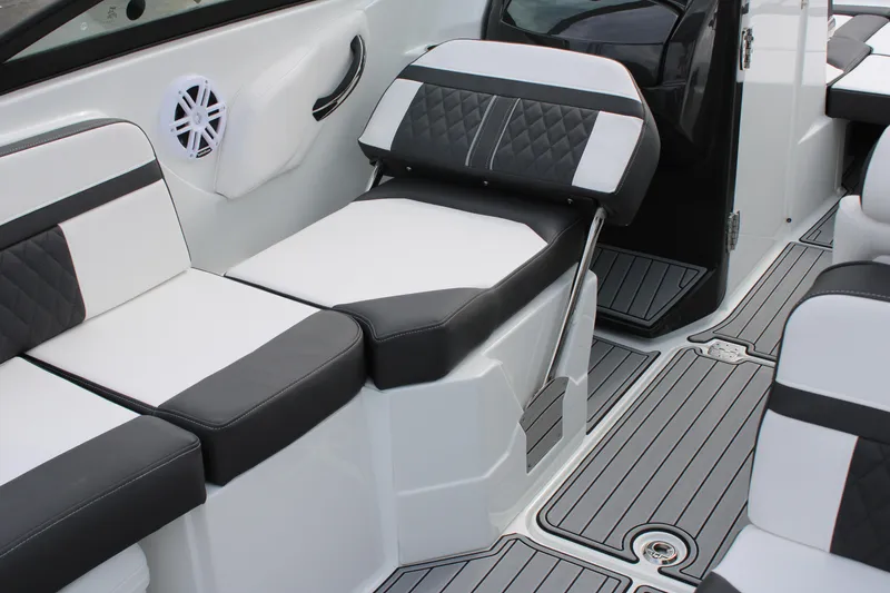 Slide: The Image of 2023 Monterey M6 boat interior with black and white seating and deck flooring. - 23