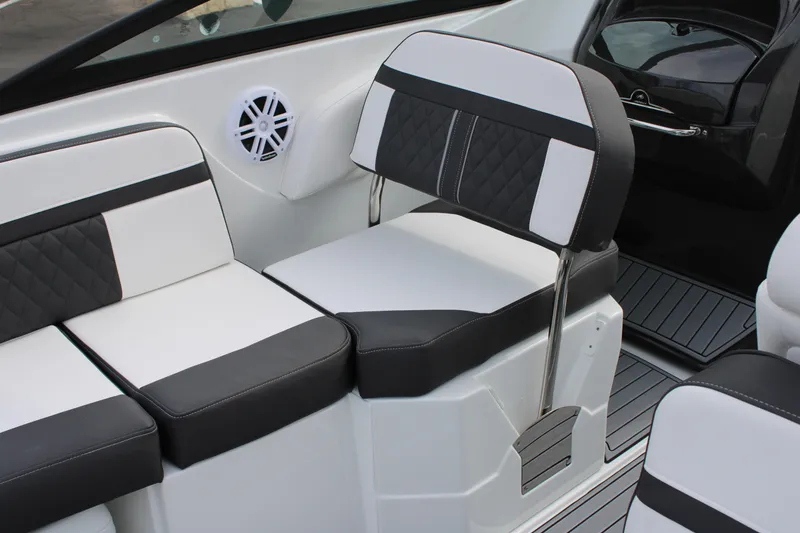 Slide: The Image of 2023 Monterey M6 boat interior with black and white seating. - 24