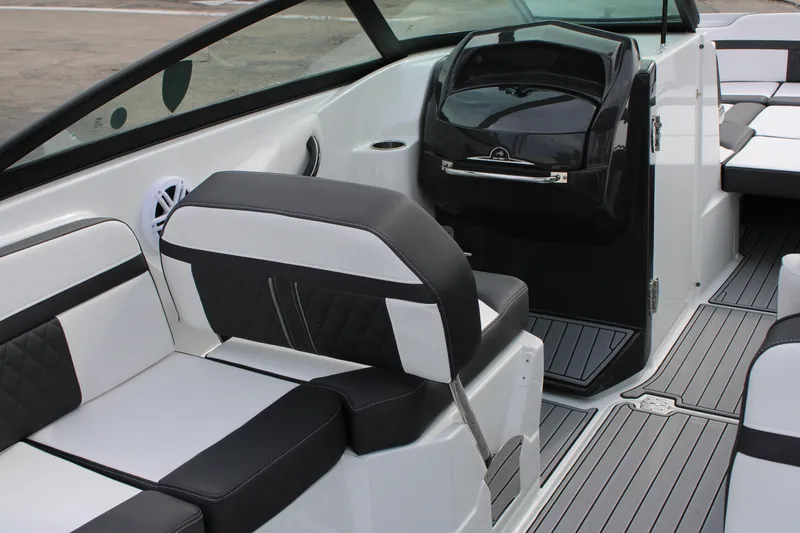 Slide: The Image of 2023 Monterey M6 boat interior with black and white seating and modern dashboard. - 25