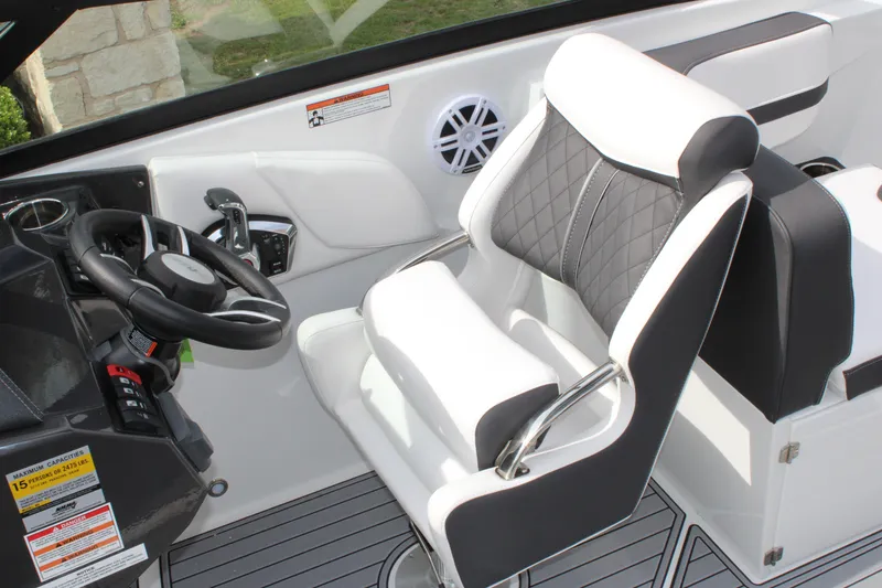 Slide: The Image of 2023 Monterey M6 boat cockpit with black and white captain's chair and steering wheel. - 31