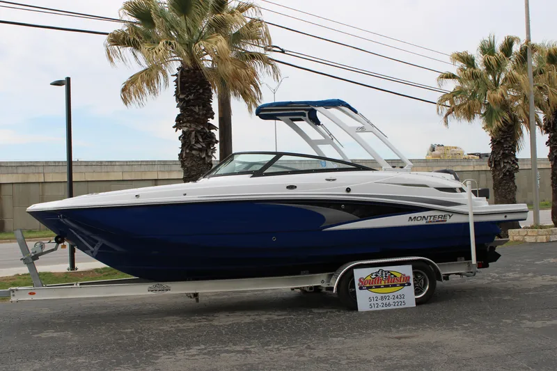 Slide: The Image of 2023 Monterey M6 boat on trailer with palm trees in background. - 5