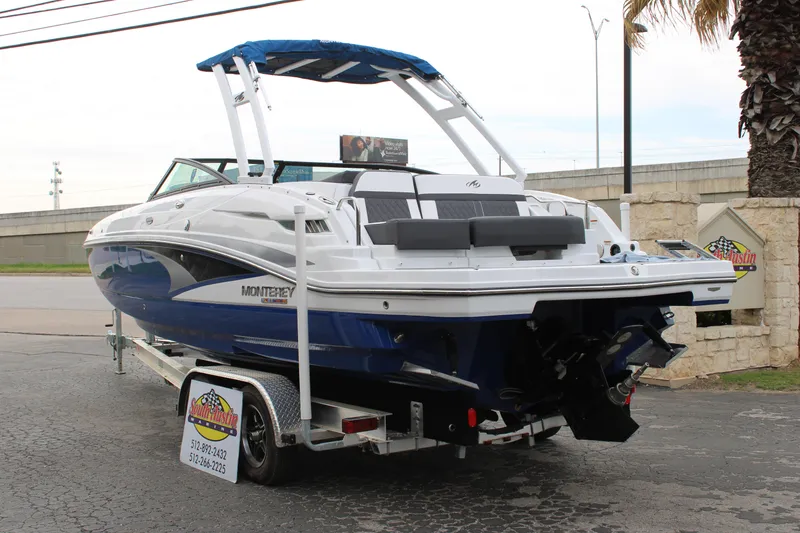 Slide: The Image of 2023 Monterey M6 boat on trailer, blue and white, rear view. - 8