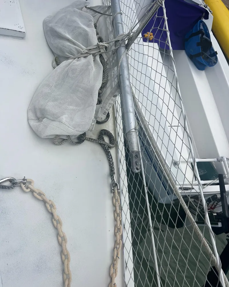Slide: The Image of 1974 CAL T2 sailboat deck with netting, ropes, and equipment. - 10