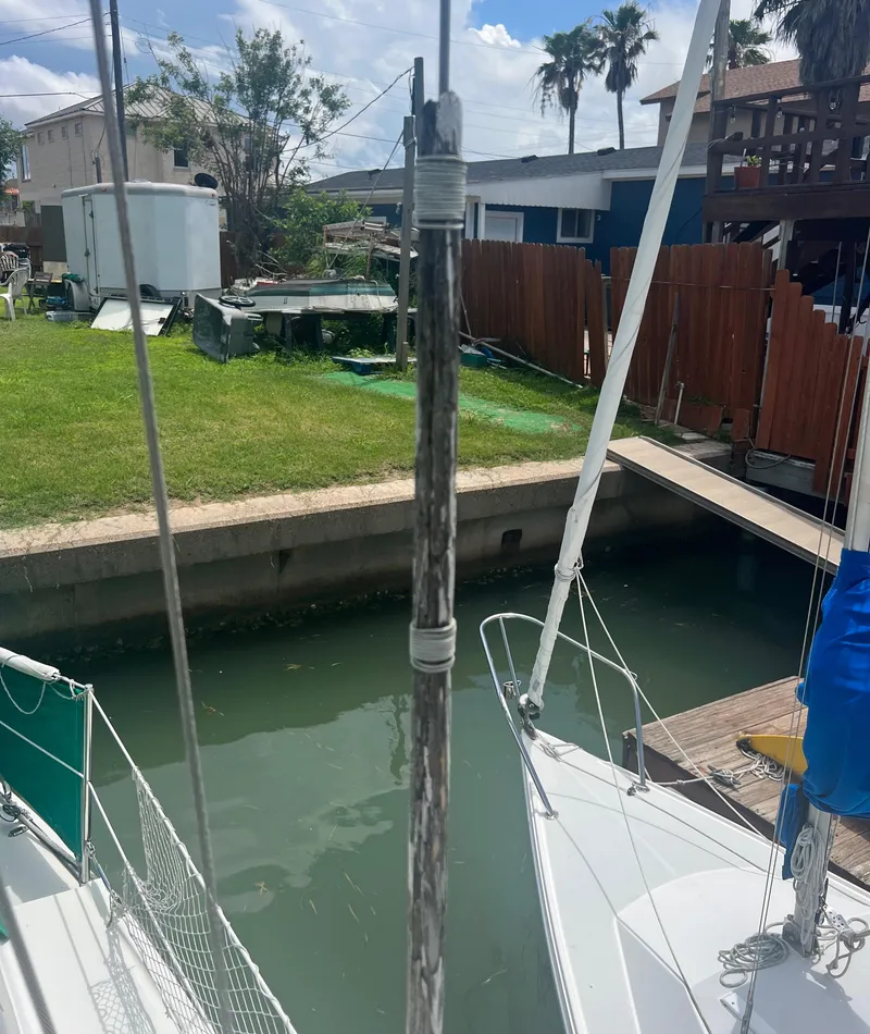 Slide: The Image of Sailboat docked in a residential canal, CAL T2 model from 1974. - 17