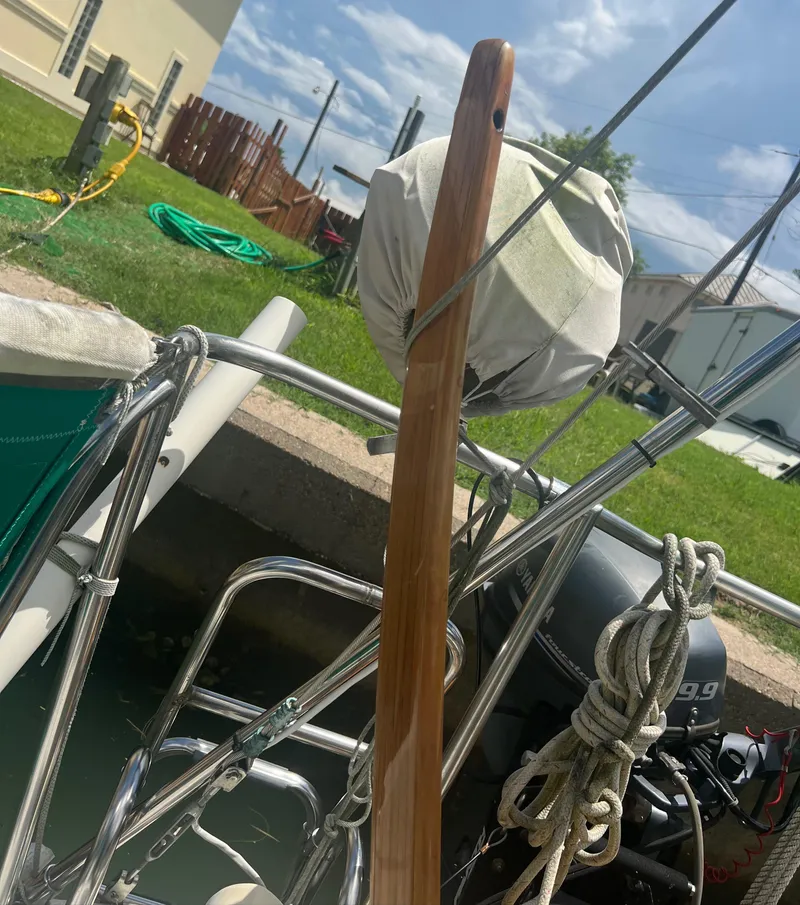Slide: The Image of 1974 CAL T2 sailboat with wooden tiller and outboard motor docked. - 20