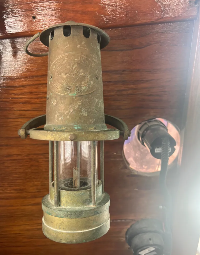 Slide: The Image of Vintage 1974 CAL T2 brass lantern on wooden background. - 32