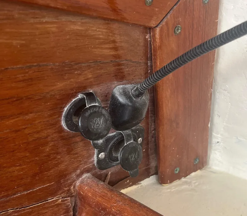 Slide: The Image of 12V power outlets on wooden panel of 1974 CAL T2 boat. - 33