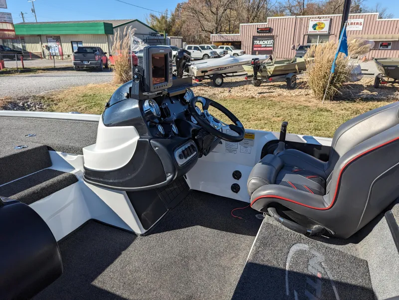 Slide: The Image of Interior of a 2012 Nitro Z8 boat with steering wheel and control panel. - 12