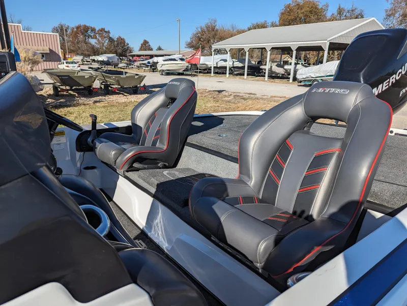 Slide: The Image of 2012 Nitro Z8 boat with dual seats, parked outdoors near other boats. - 14