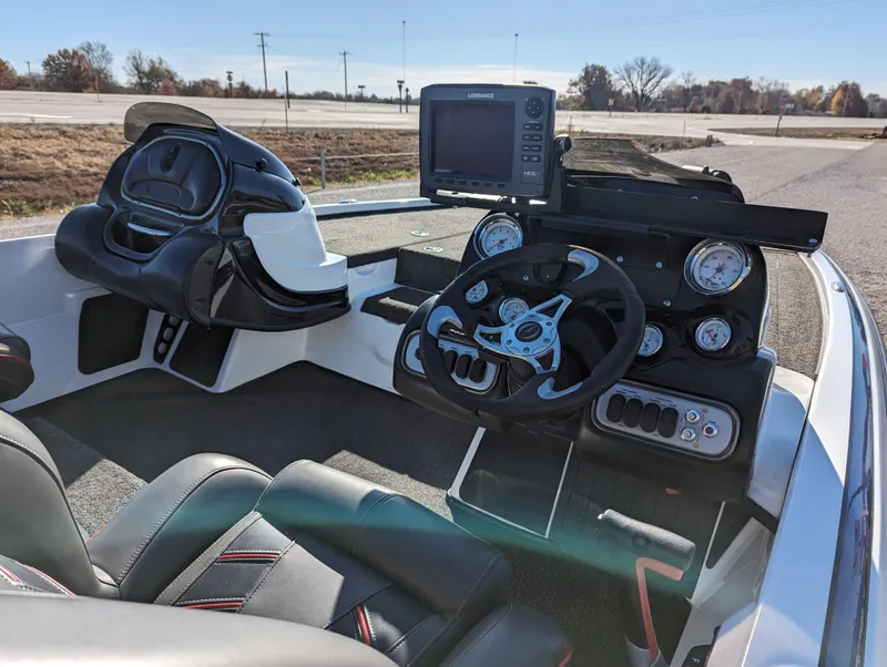 Slide: The Image of 2012 Nitro Z8 boat cockpit with steering wheel, gauges, and navigation system. - 15