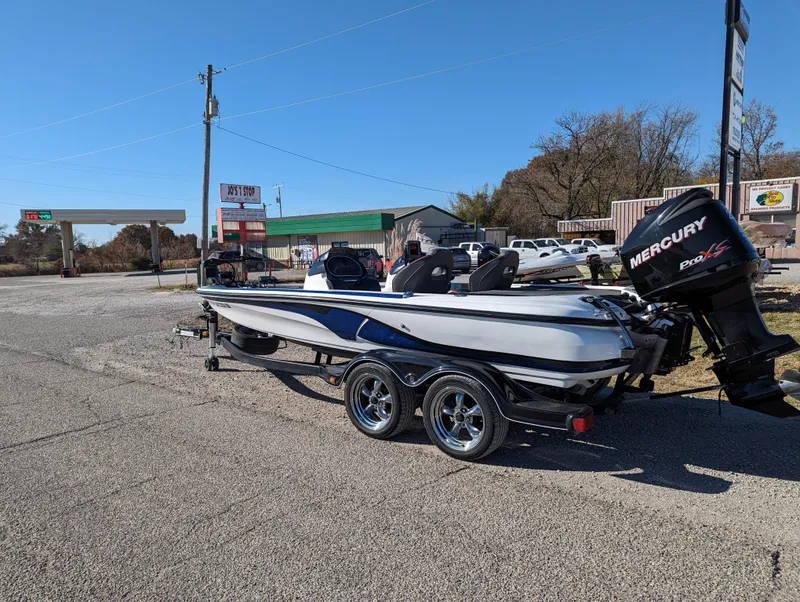 Slide: The Image of 2012 Nitro Z8 boat with Mercury Pro XS engine on a trailer in a parking lot. - 3