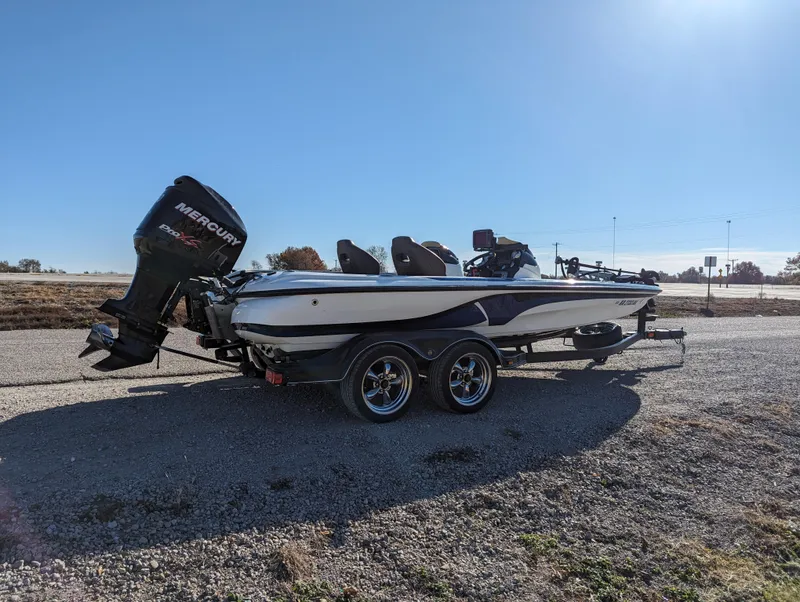 Slide: The Image of 2012 Nitro Z8 fishing boat with Mercury outboard motor on a trailer. - 7