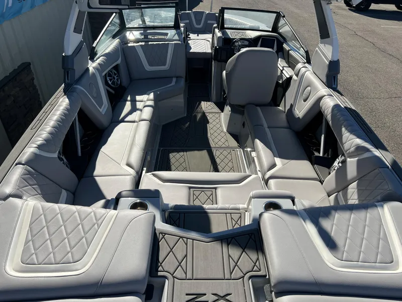 Slide: The Image of 2021 Tigé 25ZX boat interior with luxurious gray seating and modern design. - 3