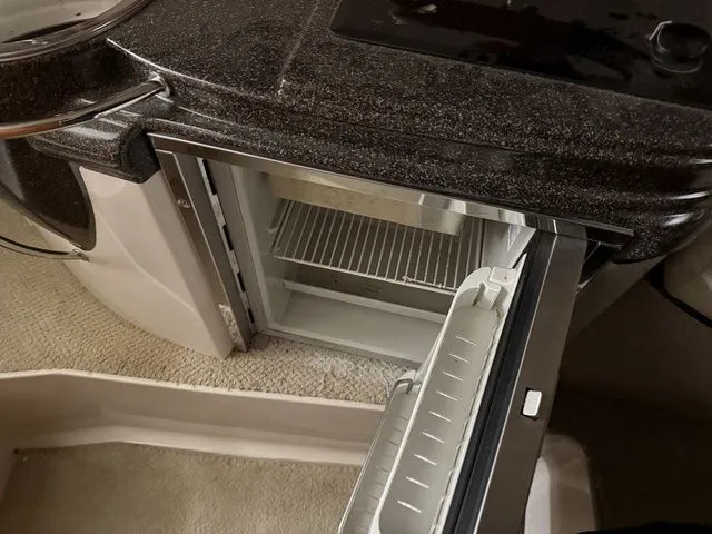 Slide: The Image of 2014 Cruisers Yachts 275 Express kitchen area with open refrigerator. - 21