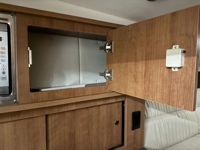 Slide: The Image of Interior of 2014 Cruisers Yachts 275 Express with wooden cabinet. - 22