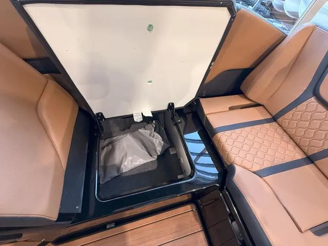 Slide: The Image of 2025 Yamaha Boats 255XD interior seating with storage compartment open. - 10