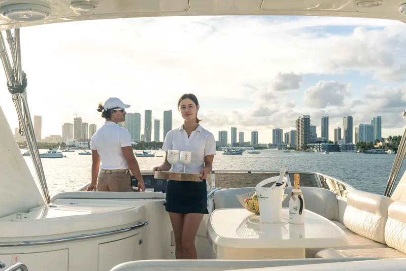 Slide: The Image of People on a 2005 Azimut 62 Evolution yacht with city skyline in background. - 11