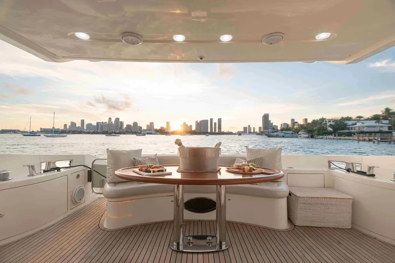 Slide: The Image of Luxurious 2005 Azimut 62 Evolution yacht deck with sunset cityscape view. - 14