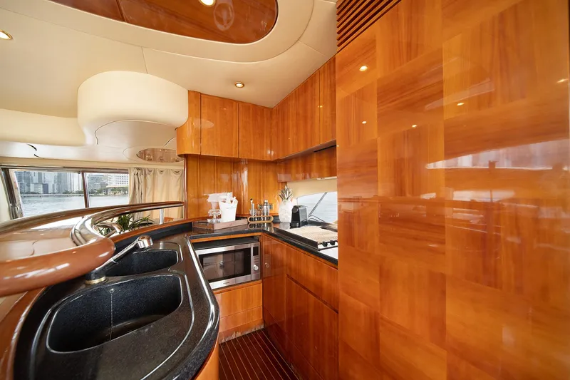 Slide: The Image of Luxurious kitchen interior of 2005 Azimut 62 Evolution yacht with wood cabinetry and modern appliances. - 21