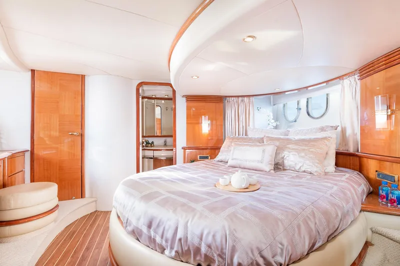 Slide: The Image of Luxurious bedroom interior of 2005 Azimut 62 Evolution yacht with elegant wood finishes. - 22