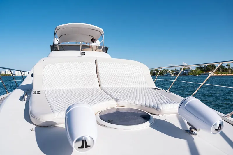 Slide: The Image of Luxurious 2005 Azimut 62 Evolution yacht with sunbathing deck on open water. - 27