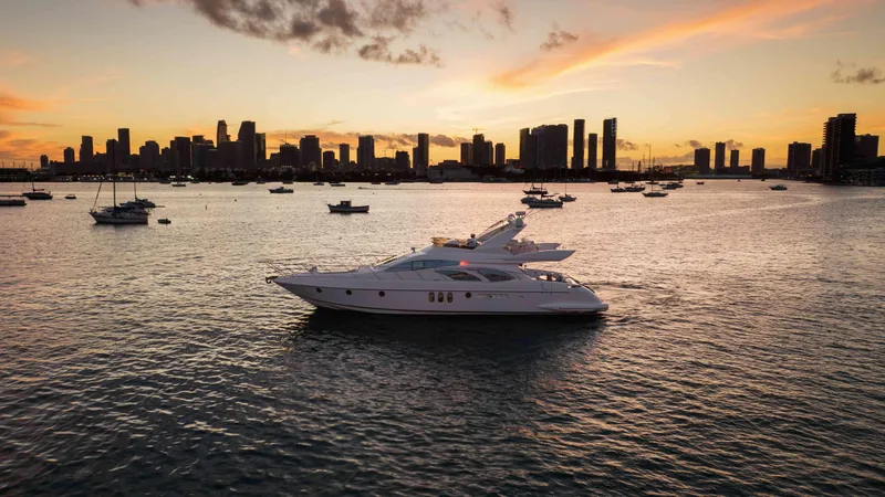 Slide: The Image of Azimut 62 Evolution yacht cruising at sunset with city skyline in background, 2005 model. - 34
