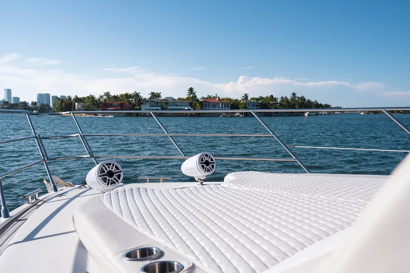 Slide: The Image of Luxurious 2005 Azimut 62 Evolution yacht deck with ocean view and coastal scenery. - 7