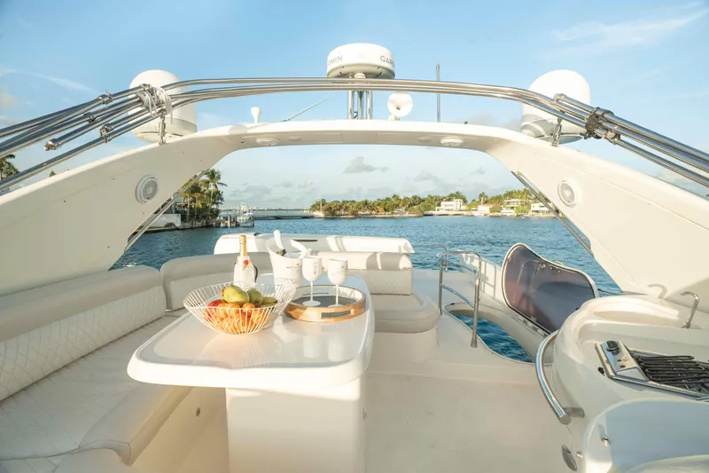 Slide: The Image of Luxurious 2005 Azimut 62 Evolution yacht deck with seating, table, and ocean view. - 9