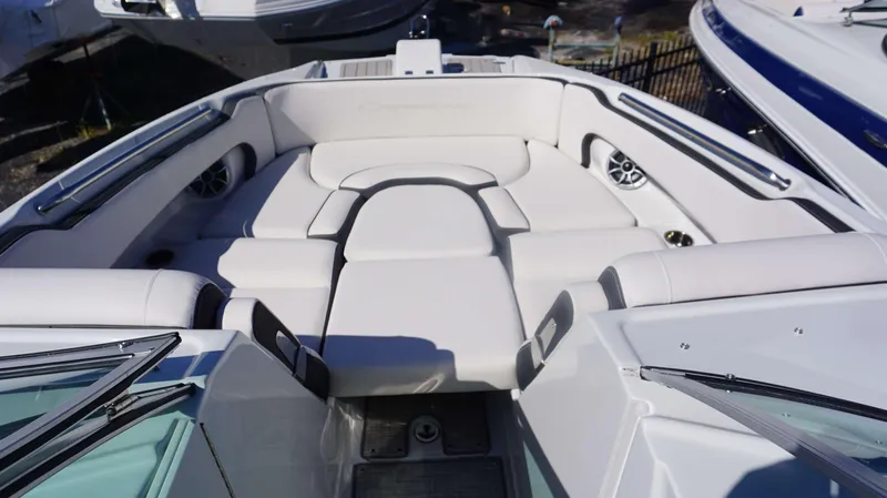 Slide: The Image of 2024 Crownline E 290 XS boat interior with white cushioned seating. - 11