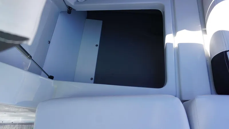 Slide: The Image of Storage compartment of 2024 Crownline E 290 XS boat with open hatch. - 16