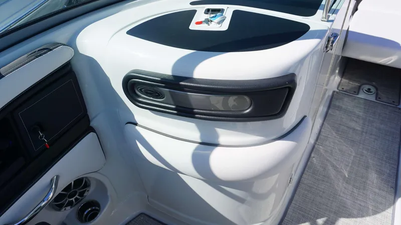 Slide: The Image of 2024 Crownline E 290 XS boat interior dashboard with key and speaker. - 4