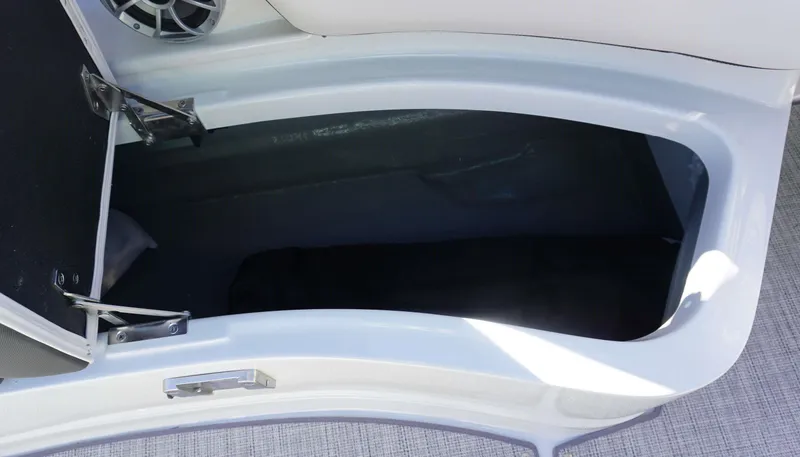 Slide: The Image of 2024 Crownline E 290 XS storage compartment with open hatch. - 6