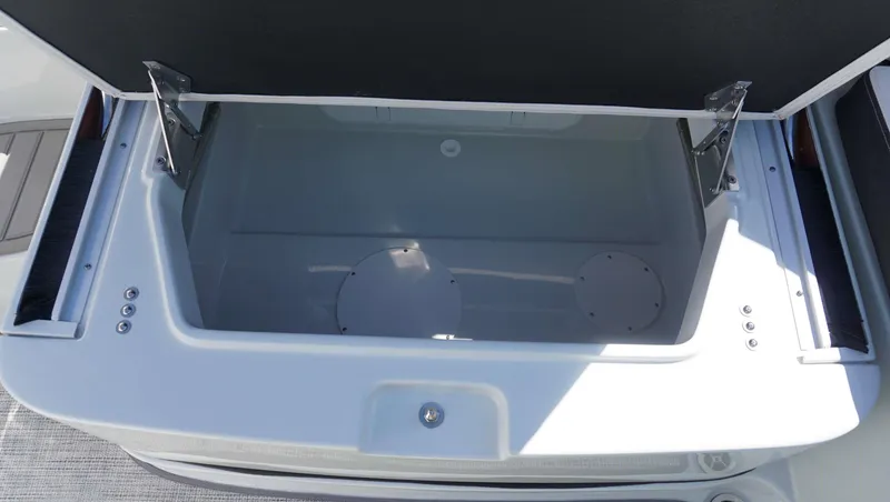 Slide: The Image of 2024 Crownline E 290 XS boat storage compartment with open lid. - 8