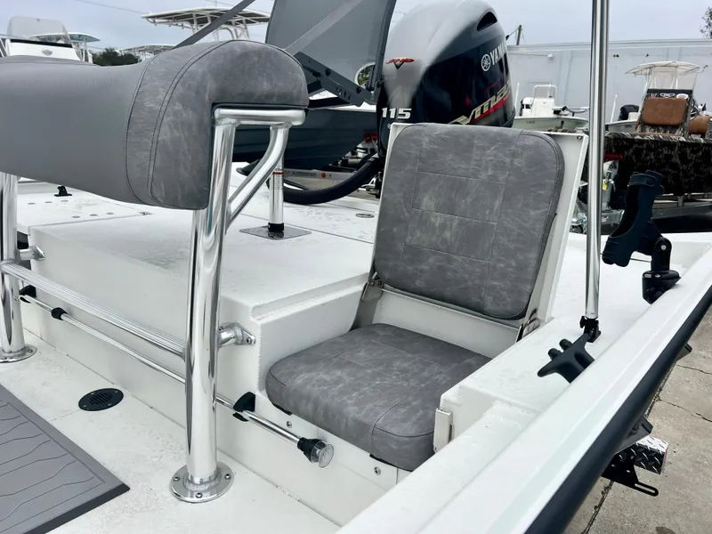 Slide: The Image of 2024 Avid 20 ROGUE CC boat interior with gray seating and Yamaha 115 engine. - 10