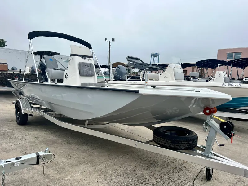 Slide: The Image of 2024 Avid 20 ROGUE CC boat on trailer in marina. - 11