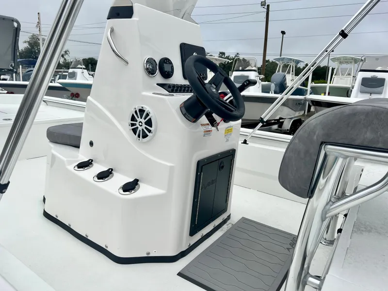 Slide: The Image of 2024 Avid 20 ROGUE CC boat console with steering wheel and controls. - 9
