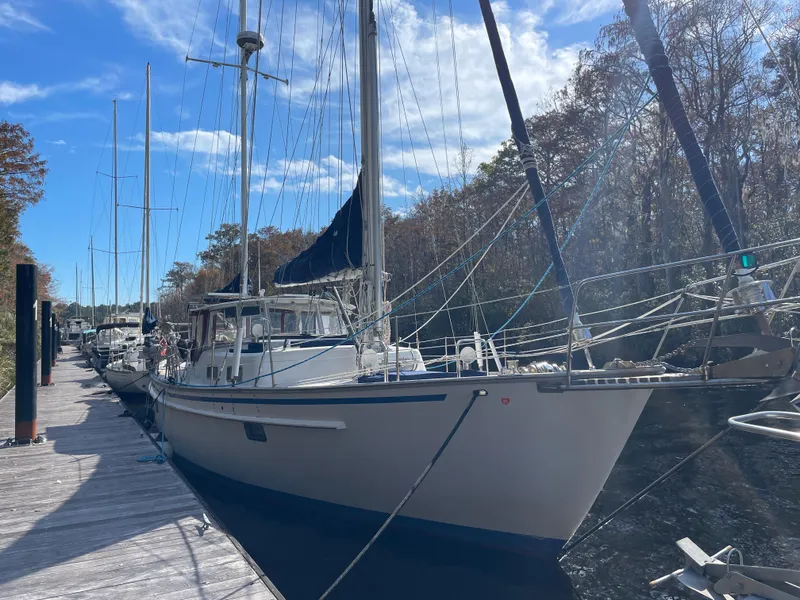 Slide: The Image of 1989 Sunward 48 sailboat docked with Yamaha outboard motor. - 1