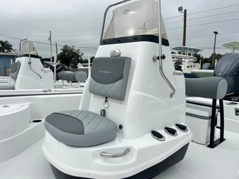 Slide: The Image of 2024 NauticStar 214 Bay boat console with cushioned seating. - 3