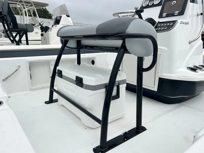 Slide: The Image of 2024 NauticStar 214 Bay boat interior with cooler and seating. - 8
