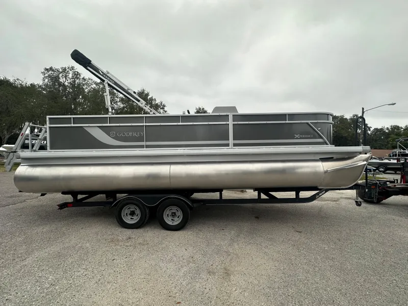 The Image of 2024 Sweetwater EX2286FX pontoon boat on a trailer, side view. - 0