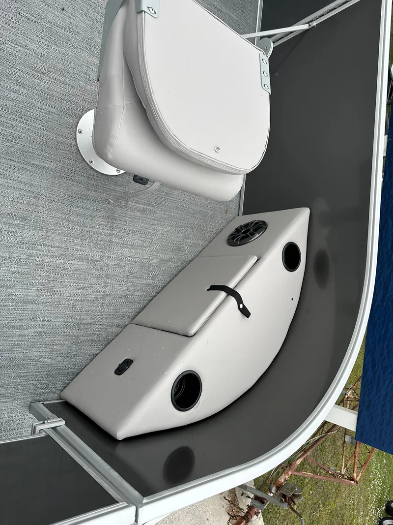 Slide: The Image of 2024 Sweetwater EX2286FX boat interior with seating and storage compartment. - 2