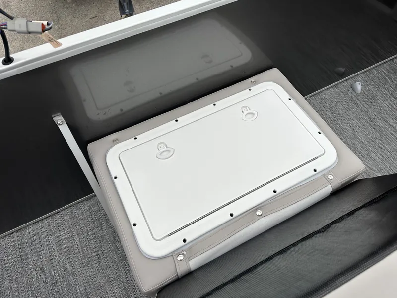 Slide: The Image of Sweetwater EX2286FX 2024 boat storage compartment with gray and black interior. - 7