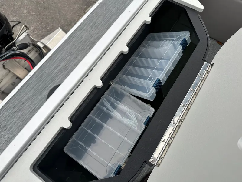 Slide: The Image of Storage compartment with tackle boxes on a 2024 Sweetwater EX2286FX boat. - 9