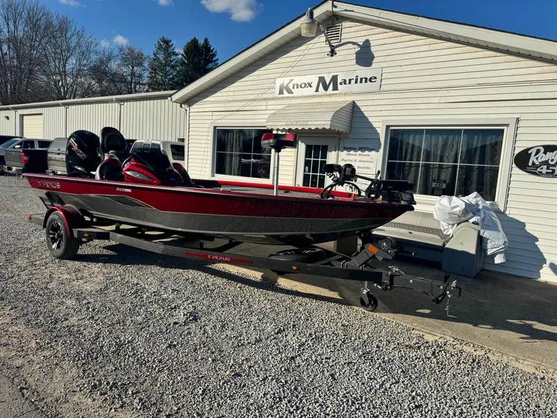 Slide: The Image of 2024 Vexus AVX1880 boat parked outside Knox Marine dealership. - 2