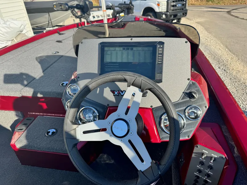 Slide: The Image of 2024 Vexus AVX1880 boat dashboard with steering wheel and electronic display. - 5