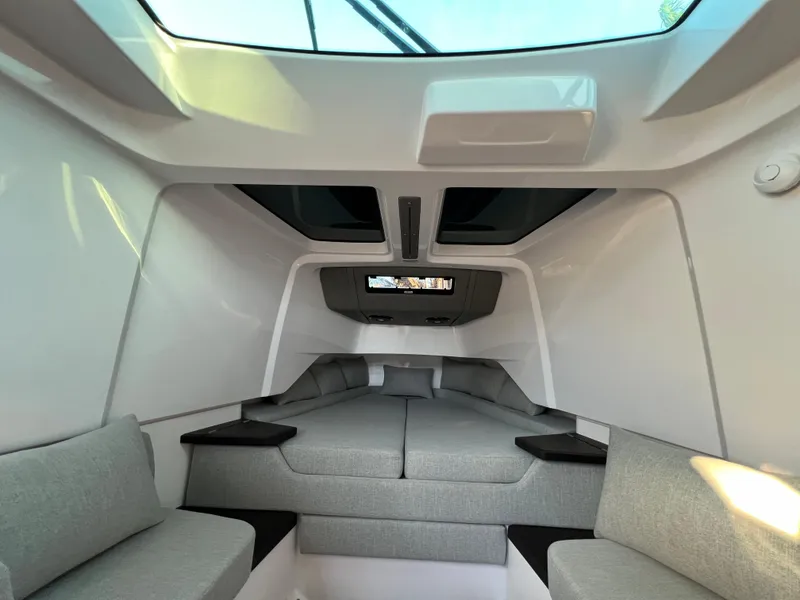 Slide: The Image of Interior cabin of 2023 Axopar 37 Sun-Top with modern seating and skylight. - 22